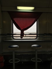 Fototapeta na wymiar window in the interior of the old train car