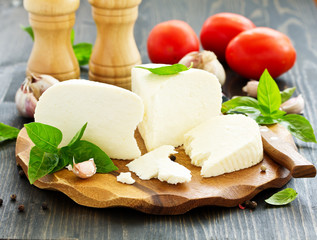 cheese brynza  and garlic on a cutting board.