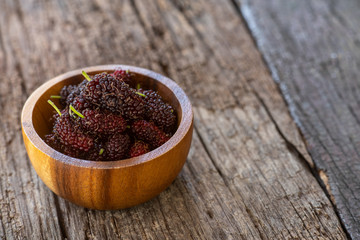Fresh mulberry fruit on wood table background