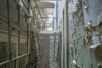 Old prison corridor with open cells.