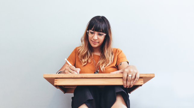 Close up of an illustrator working on her drawings