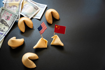 Chinese fortune cookies next to American flag, concept of international trade between USA and China.