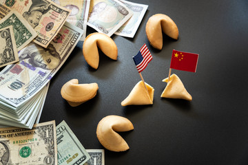 concept of commercial war between USA and China, with dollar bills and flags of the capitalist countries and biscuit.