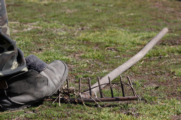 Garden rakes lying on the ground. Concept make the mistake twice. To step on the rakes.