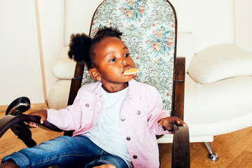 little cute african american girl playing with animal toys at home, pretty adorable princess in interior happy smiling, lifestyle people concept close up