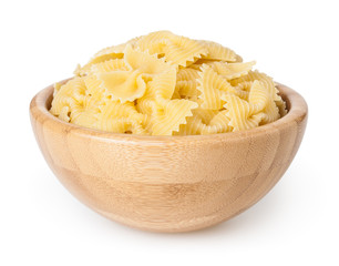 Farfalle pasta in wooden bowl isolated on white background with clipping path