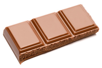 Milk organic chocolate pieces isolated on white background