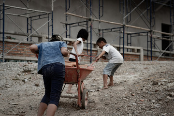 Child labor in building commercial building structures. World Labor Day concept