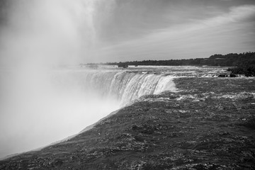 On the top of the Niagara Falls. Black and White. The spectacular Horseshoe Fall that lies on the border of the United States and Canada