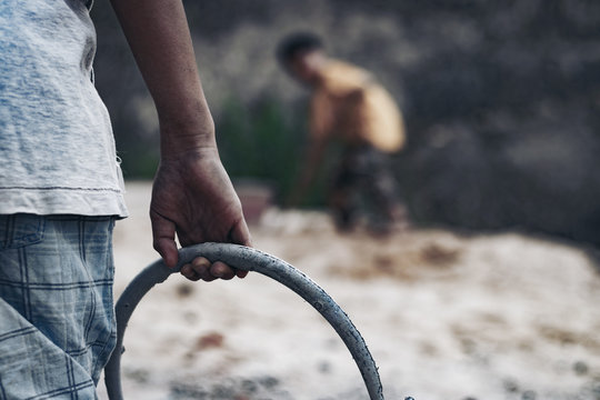 Child labor in building commercial buildings. World Labor Day concept.
