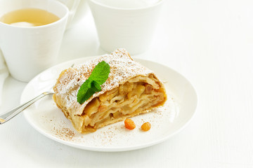 apple strudel with cinnamon and an ice cream ball.