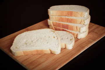 sliced white bread on wooden board