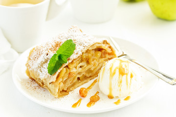 apple strudel with cinnamon and an ice cream ball.