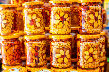 assorted nuts in a jar of honey, nutritious food
