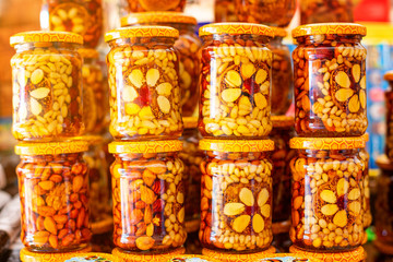assorted nuts in a jar of honey, nutritious food