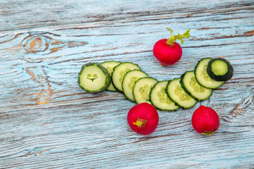 sliced cucumber and radish in the form of a caterpillar