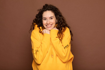 Portrait with copy space empty place of cheerful laughter funny comic girl . Beautiful american girl with an afro hairstyle smiling. Happy woman with curly hair. sincere girl