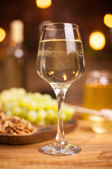 Close up photo of a glass of white wine on a wooden table