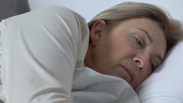Woman patient feeling bout in hospital, pushing button to call nurse for help