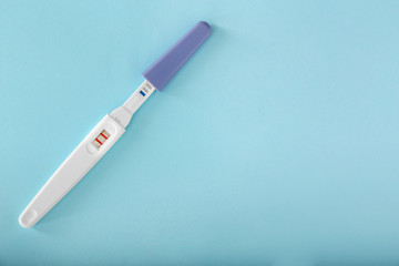 Positive pregnancy test on color background