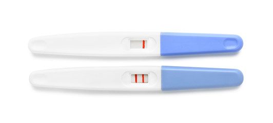 Negative and positive pregnancy tests on white background