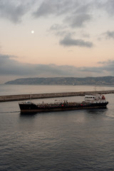 merchant ships in the Mediterranean Sea at sunset