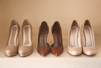 Collection of new female shoes on shelf in shop