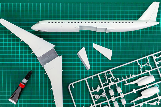 Aircraft Layout Assembly,  Model   Plane Building On Wooden Table With Scale Modelling Tools.