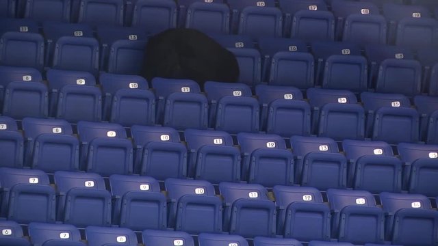 police shepherd sniffs blue empty seats at the hockey stadium
