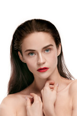 A beautiful female face. Perfect and clean skin of young caucasian woman on white studio background.