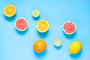 Citrus fruits flat lay on the blue background