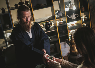 Woman attending tea ceremony performed by master
