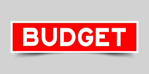 Square red color sticker with word budget on gray background