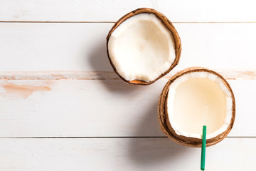 Coconut, coconut milk on white wooden background. Top view.