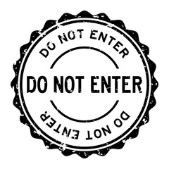Grunge black do not enter word round rubber seal stamp on white background