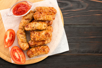 Tasty grilled sausage on the wooden background. Top view with copy space