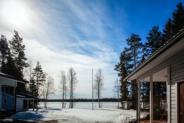 Winter landscape - Houses stand by the lake on a Sunny day