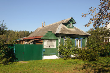 Green wooden house in the village