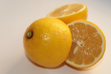 Lemons lie on a white background, cut in half