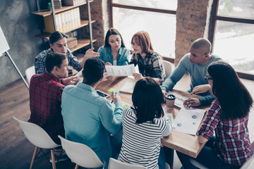 Focused concentrated motivated managers coworkers associates professionals in casual shirts leader leadership have appointment analyze strategy communicating in office boardroom top view picture