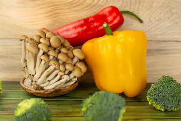 Mushrooms, hot pepper and paprika, on a wooden background