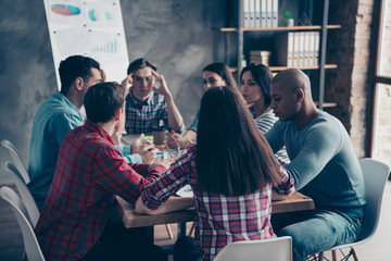 Confident thoughtful leaders leadership thinking about successful strategy having conversation gather together at table wearing checkered casual shirts 