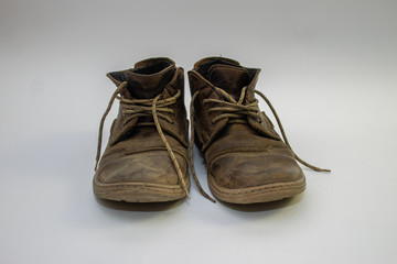 Old worn men's shoes with nubuck laces on a light background, men's shoes