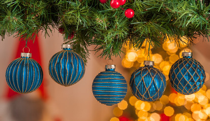 Christmas balls on a Christmas tree with light on background