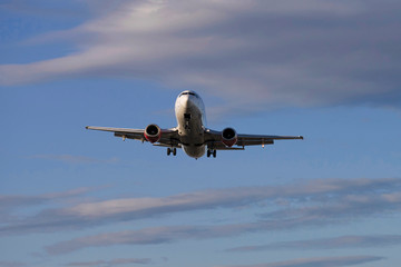 Flying passenger Airplane preparing to land