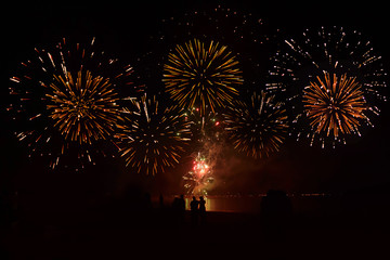 Fototapeta na wymiar Fireworks light up the night sky over Nai Yang Beach, Phuket, Thailand