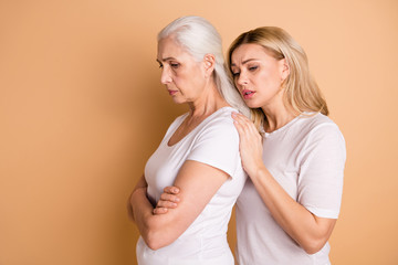 Profile side view photo disappointed sullen granny ashamed depressed stress adult disagreement grey hairdo no communication offense apology touch shoulders trendy outfit isolated beige background
