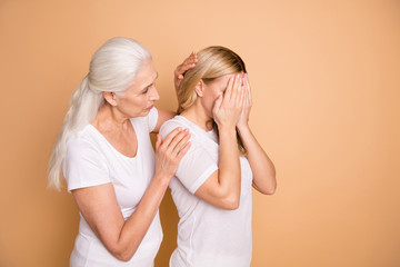 Portrait of nice attractive gloomy grumpy moody worried ladies wearing white outfit granny mom supporting grandchild cheering up sorrow isolated over beige pastel background