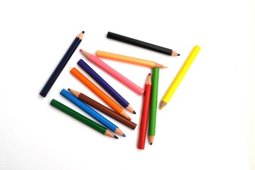 colored pencils in a set of twelve colors on a light background