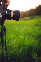hand with camera in grass	